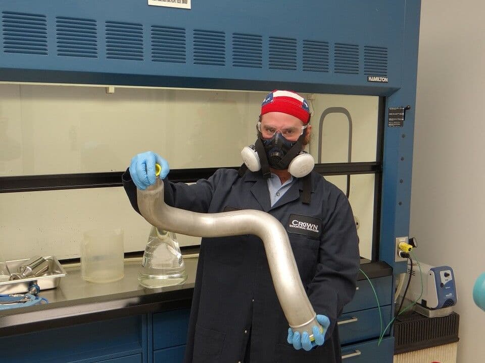 Technician performing an agitation extraction for industrial cleanliness testing