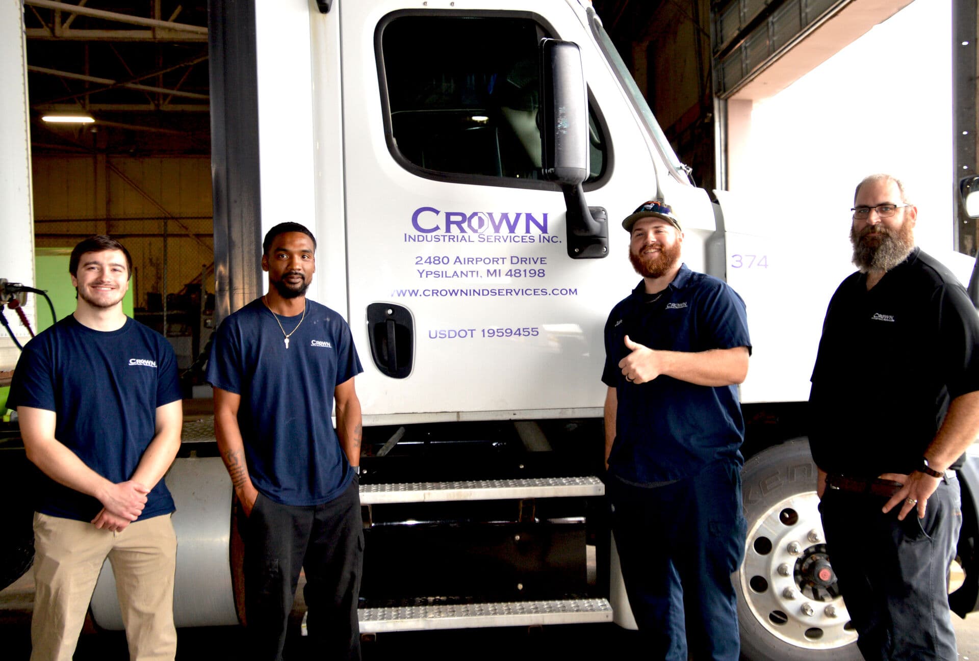 Crown Industrial Services team members standing beside a company truck