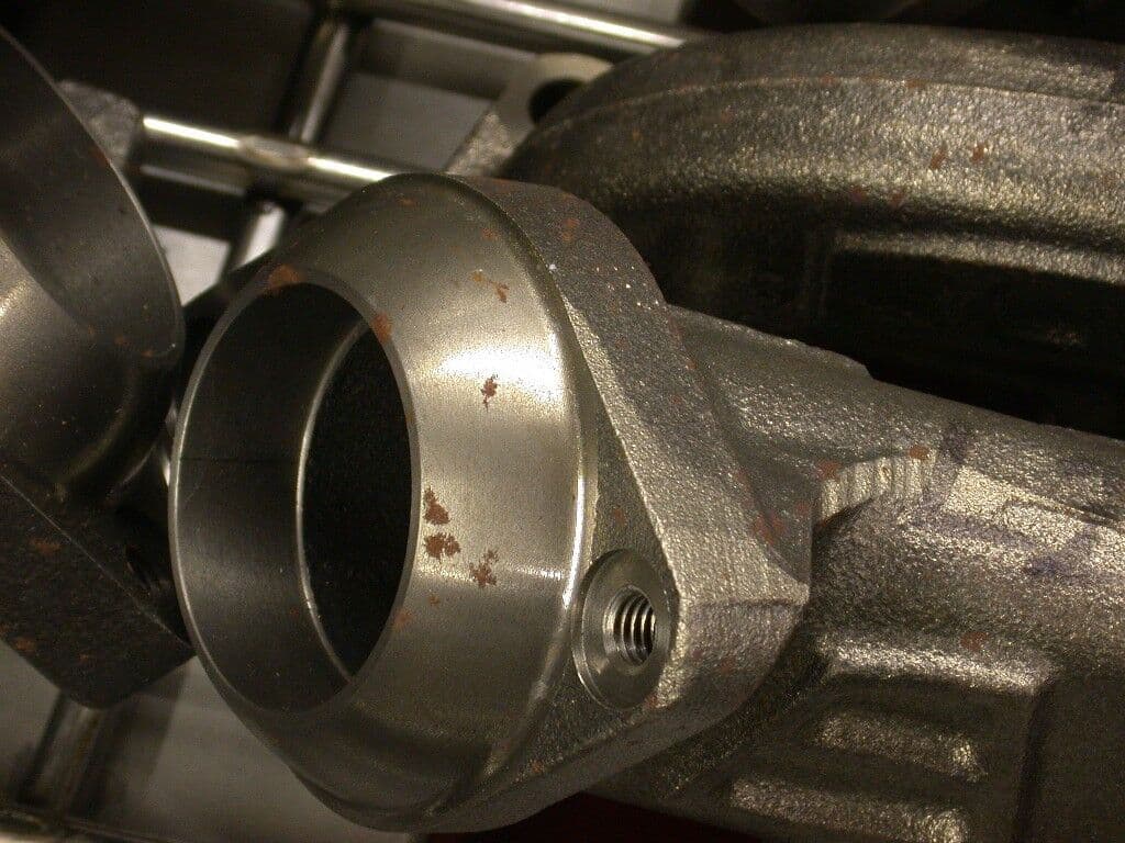Corroded metal manifold before rust removal