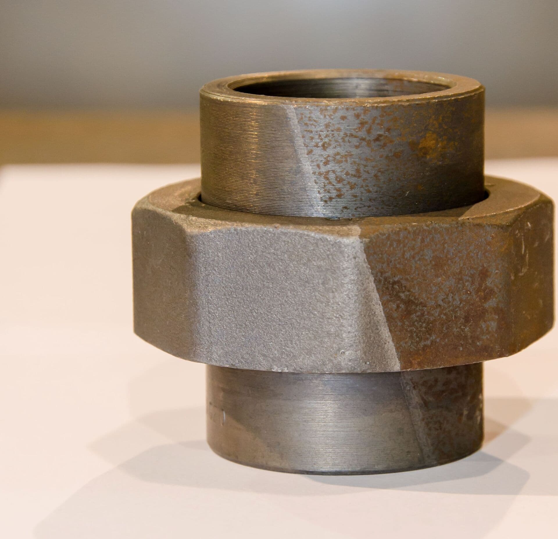 Metal fitting showing before-and-after rust removal