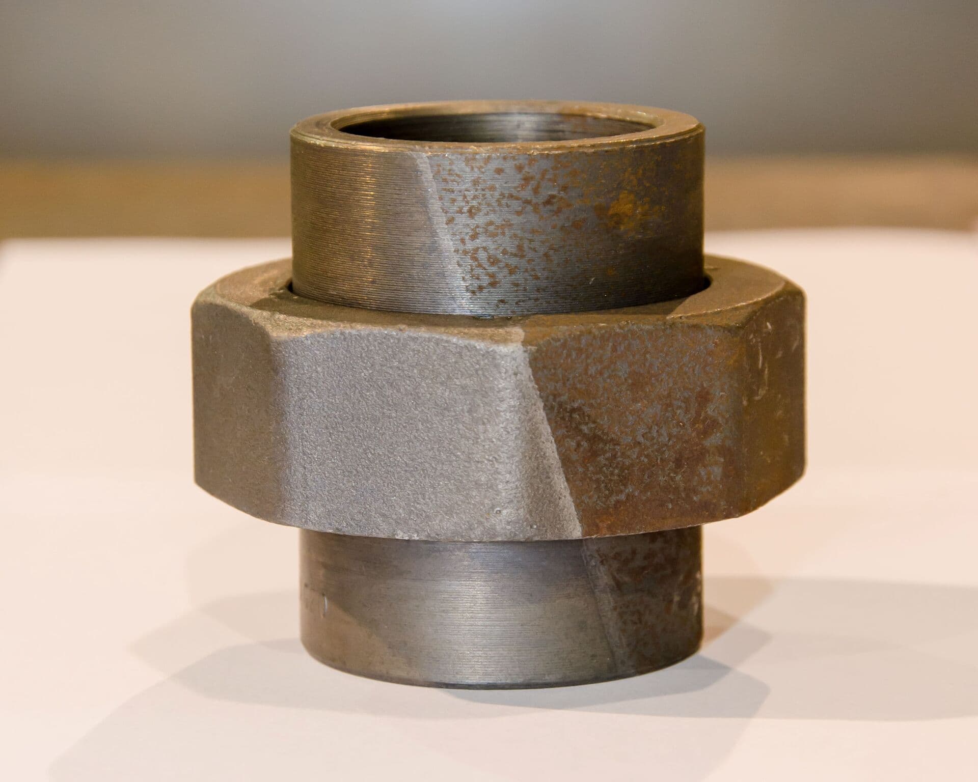 Metal fitting showing the result of industrial rust removal