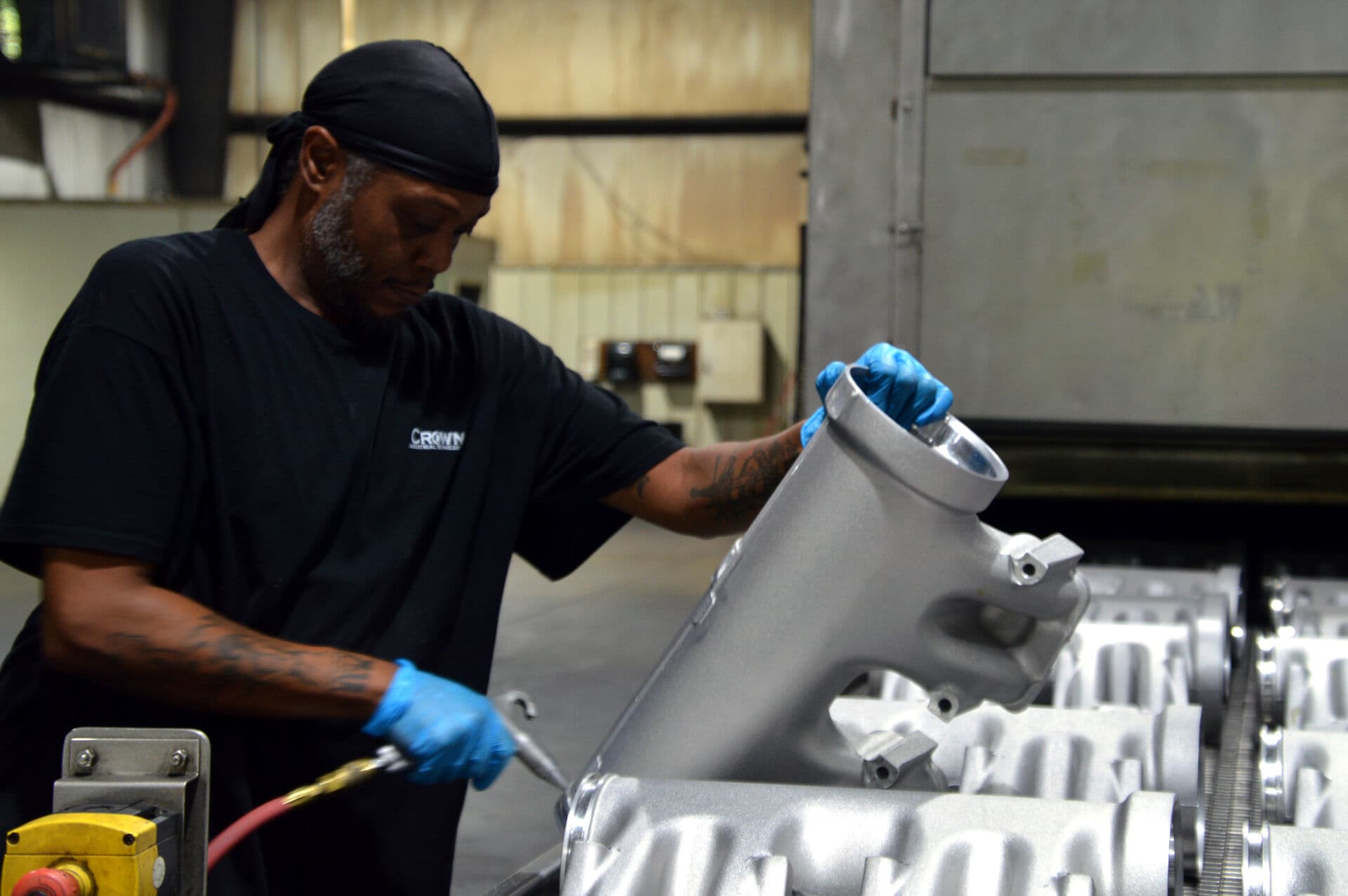Technician performing precision cleaning on a metal part